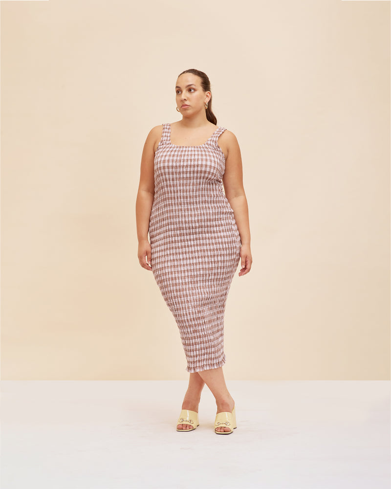 KLEIN GINGHAM MIDI DRESS LILAC GINGHAM | Shirred midi dress with a scoop neckline and ruffle hem detail in a playful lilac and brown. The shirring adds texture to the piece while also ensuring it fits closely...