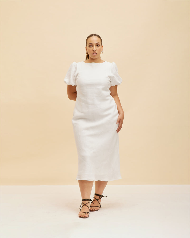 KOS LINEN DRESS WHITE | Bias cut dress with a subtle puff sleeve and cut out back with neck-ties. Cut in a white linen, this piece is designed to perfectly skim over your body, while...