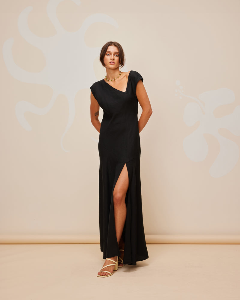 BEIGNET DRESS BLACK | Cap-sleeve maxi dress with a feature asymmetrical neckline. Has a front split for ease of movement.