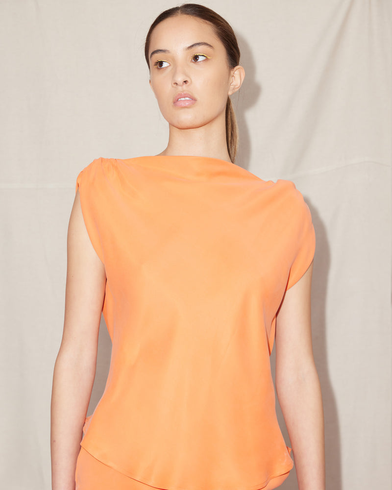  CURTIS SLEEVELESS BLOUSE ORANGEADE | Bias cut cap sleeve blouse crafted in a lush orangeade cupro. This piece has ruched detail at the shoulder, a tie to cinch in the waist, and a high neckline...