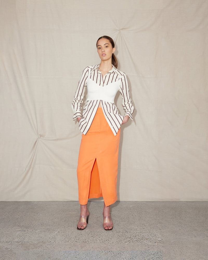  BEIGNET SKIRT ORANGEADE | Midi length pencil skirt designed in a playful orangeade cupro. With considered details such as front pockets, belt loops and an invisible back zip, the Beignet Skirt is made for...