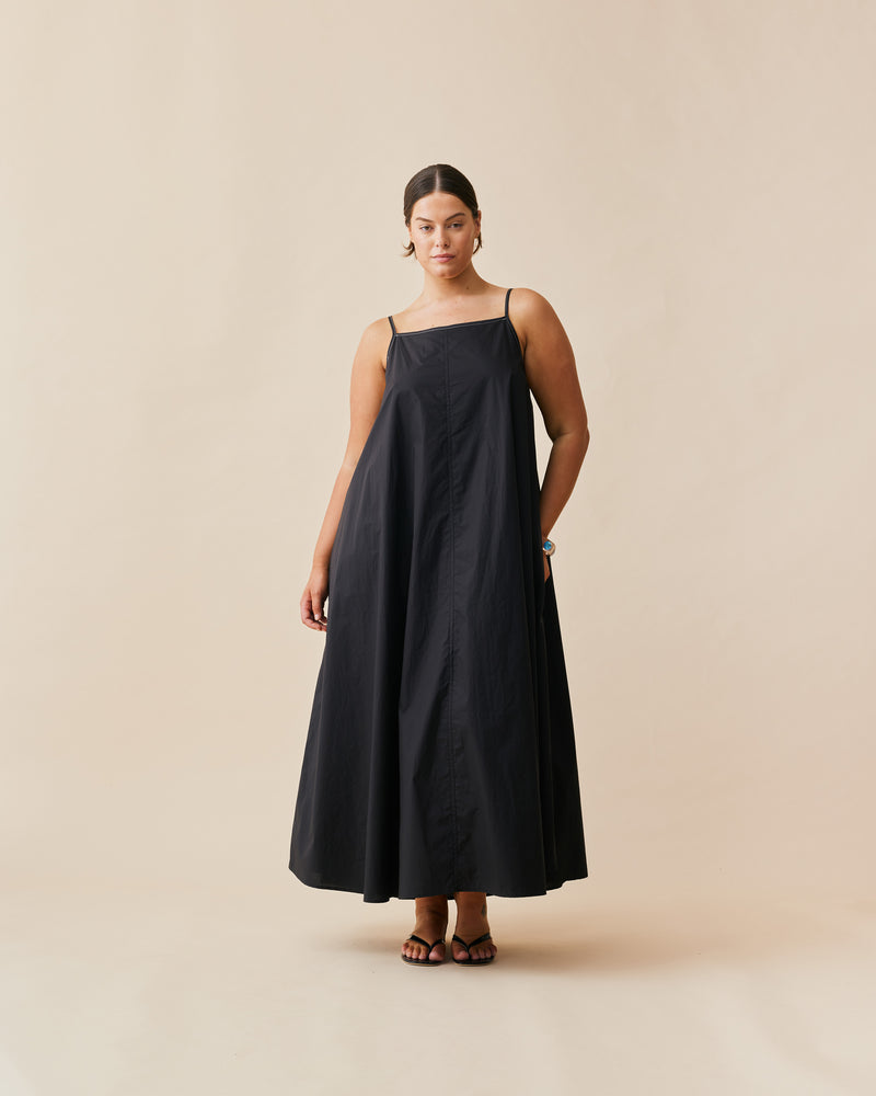 JULIA DRESS BLACK | Maxi slip dress designed in a crisp black organic cotton. This dress has a square neckline and spaghetti straps with contrast stitch detailing and falls to a floaty A-line shape...