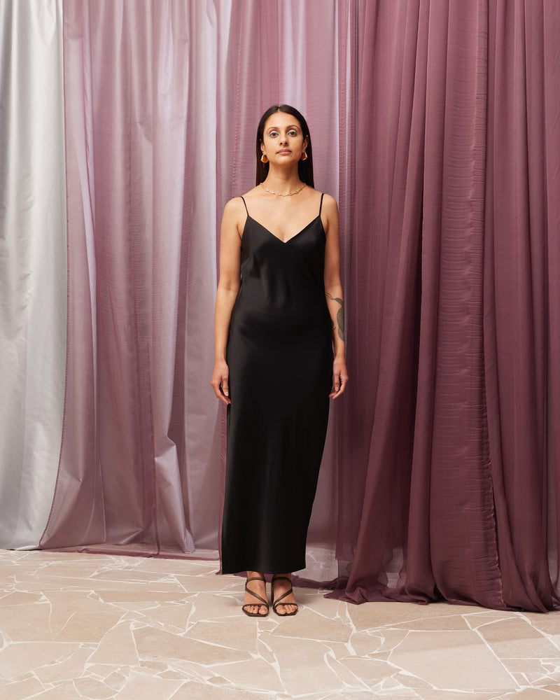 LOLA SLIP DRESS BLACK | V-neck slip dress designed in a soft satin fabric. This dress features a built in bust shelf for extra support, and comes with a detachable tie for you to style...