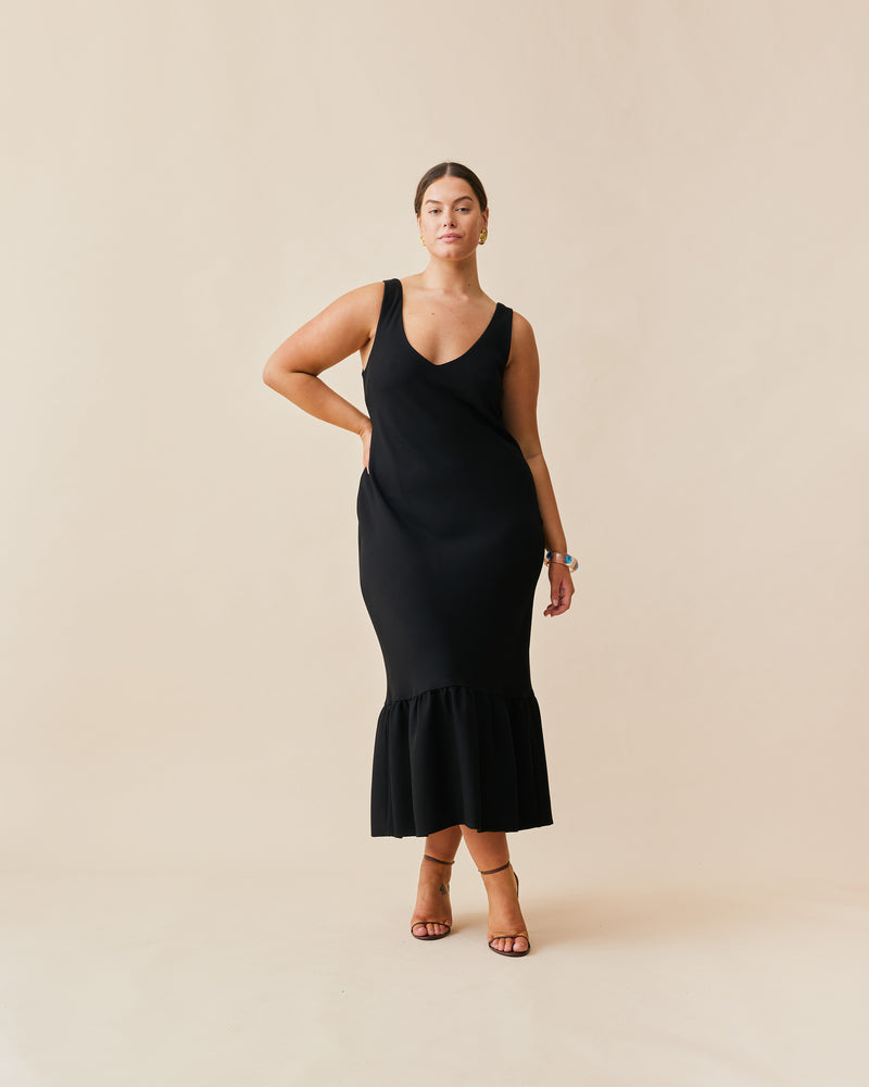 ROBIN PUFF DRESS BLACK | Slim fit bias maxi dress in with puff hem. This dress has a low, V-neckline and is sleeveless, with straps wide enough to cover bra straps.