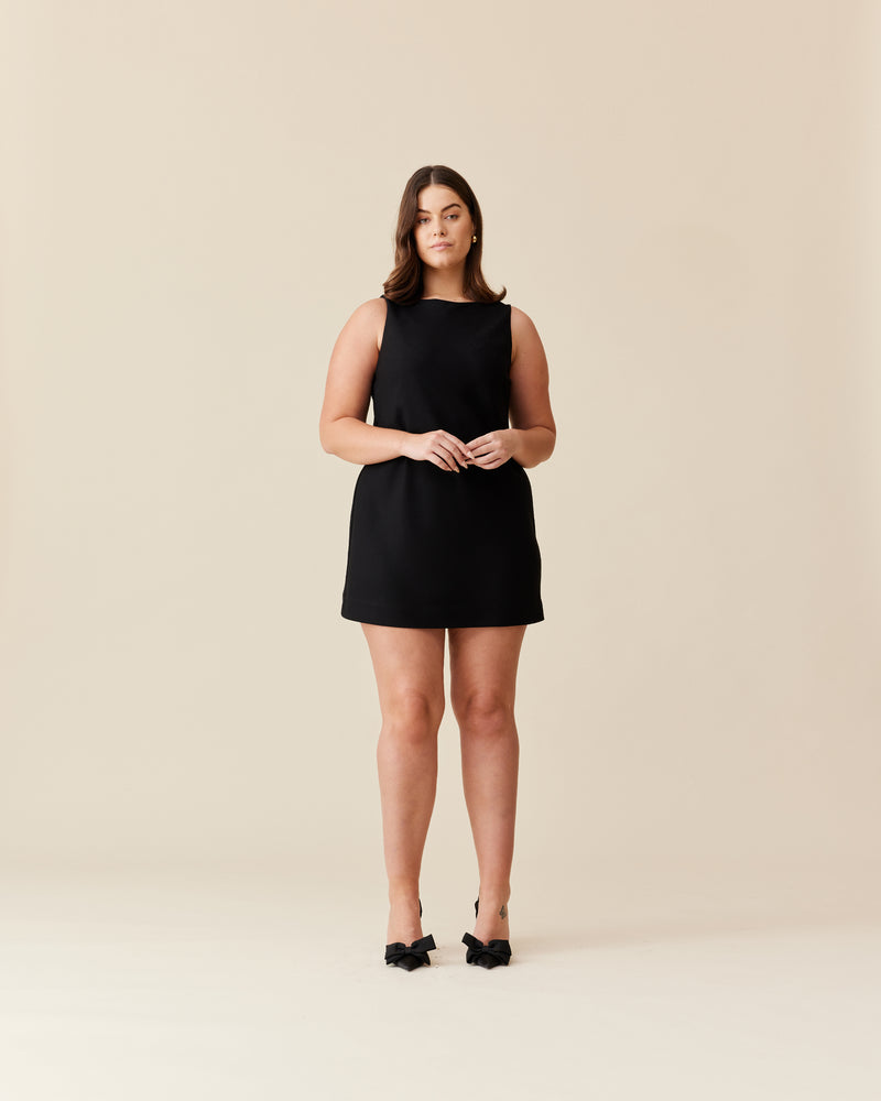 ROBIN MINIDRESS BLACK | Bias cut dress in mini dress with a boat neckline. This dress is designed in a light-weight twill fabric. The perfect little black dress.
