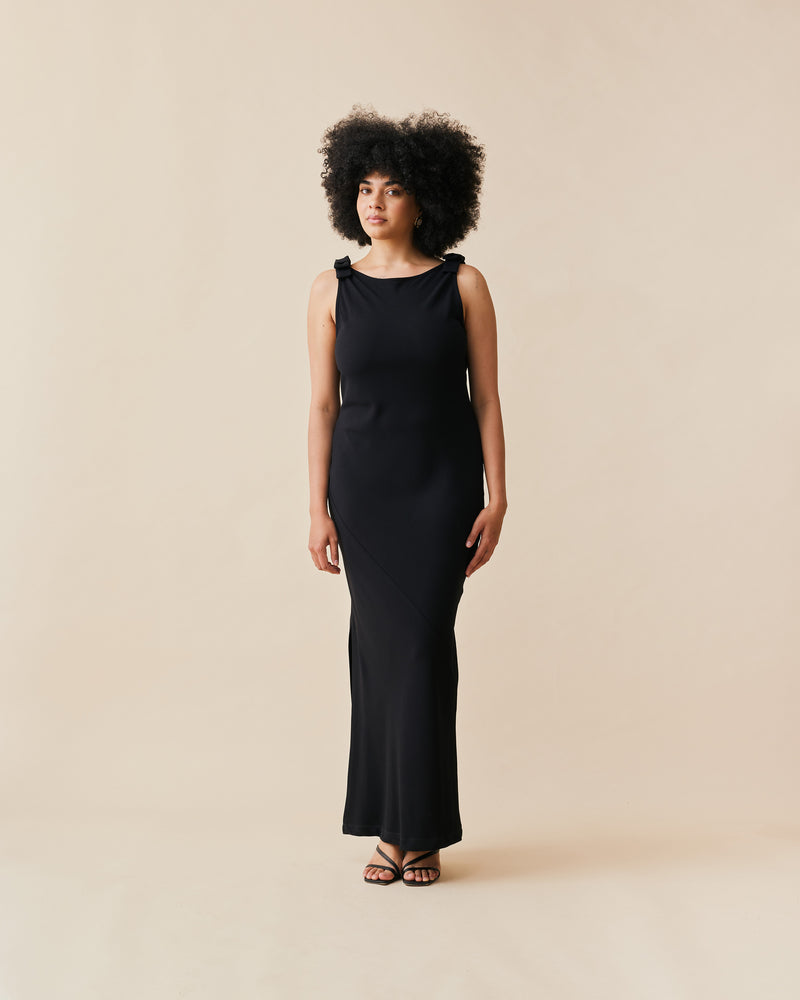 BLACK TIE GOWN BLACK BLACK | The iconic Black Tie Gown returns, in our signature firebird crepe. This gown features a bias cut, a plunging cowl back, and bow detailing at the shoulders. 
