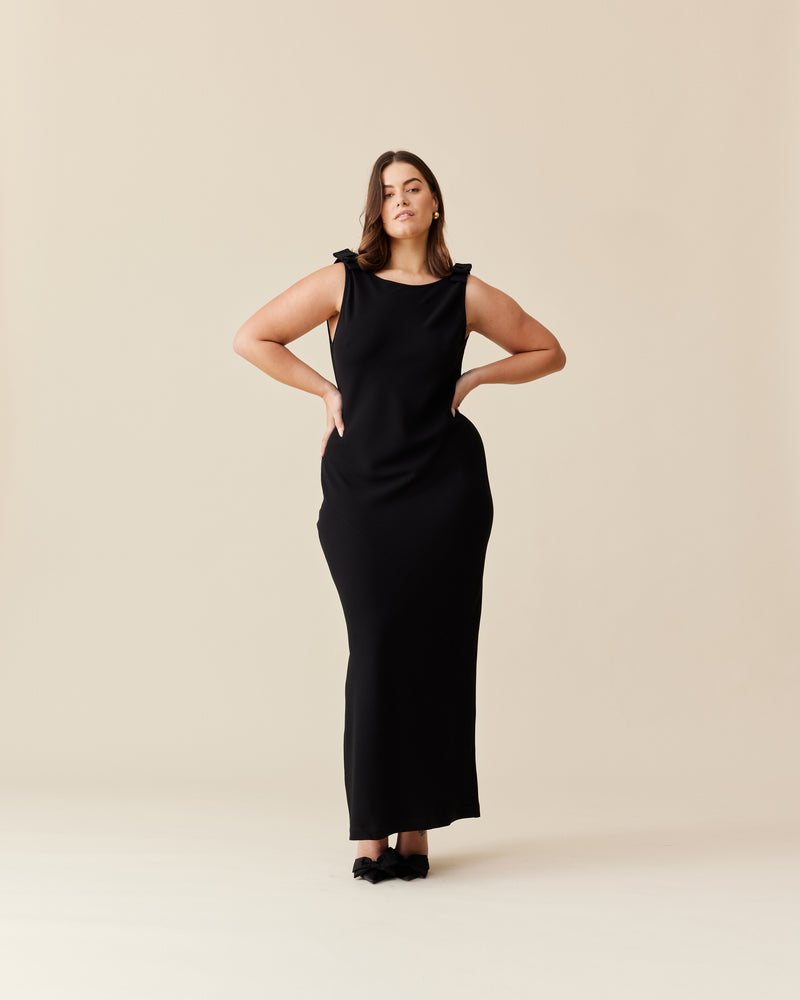 BLACK TIE GOWN BLACK BLACK | The iconic Black Tie Gown returns, in our signature firebird crepe. This gown features a bias cut, a plunging cowl back, and bow detailing at the shoulders. 
