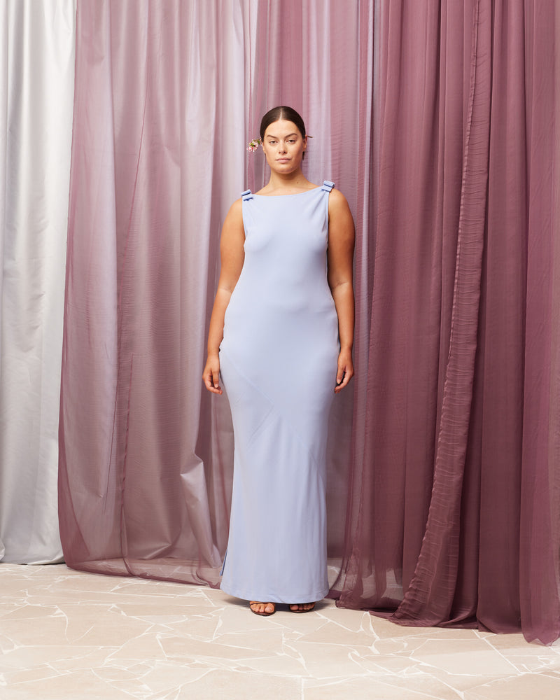 BLACK TIE GOWN SERENITY | The iconic Black Tie Gown returns, in our signature firebird crepe in a soft serenity blue. This gown features a bias cut, a plunging cowl back, and bow detailing at...