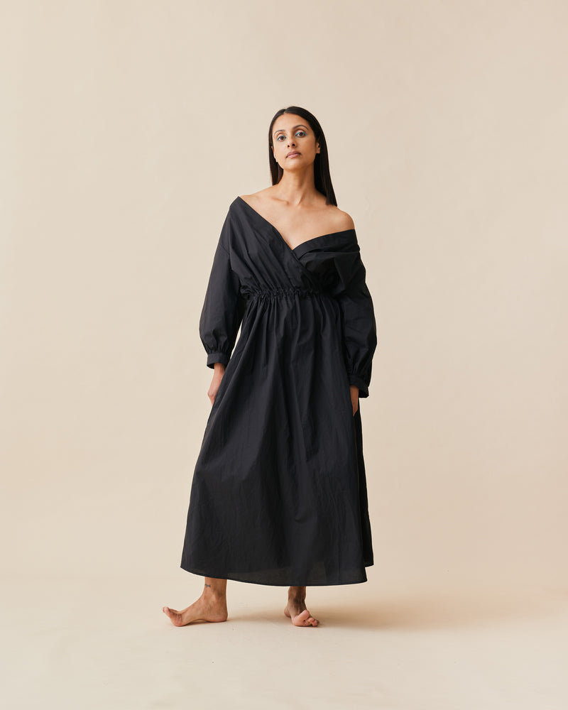 DELILAH WRAP DRESS BLACK | Cotton midi dress with an elasticated waist and has cuffs at the sleeves. This dress has a faux wrap detail and pockets to house all your essentials.