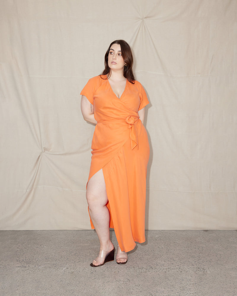  OMNIA CAPSLEEVE WRAP DRESS ORANGEADE | Cap sleeve, full-length bias cut wrap dress cut from a lustrous orangeade cupro. This dress is a full wrap through so you can wear this piece as open or covered...