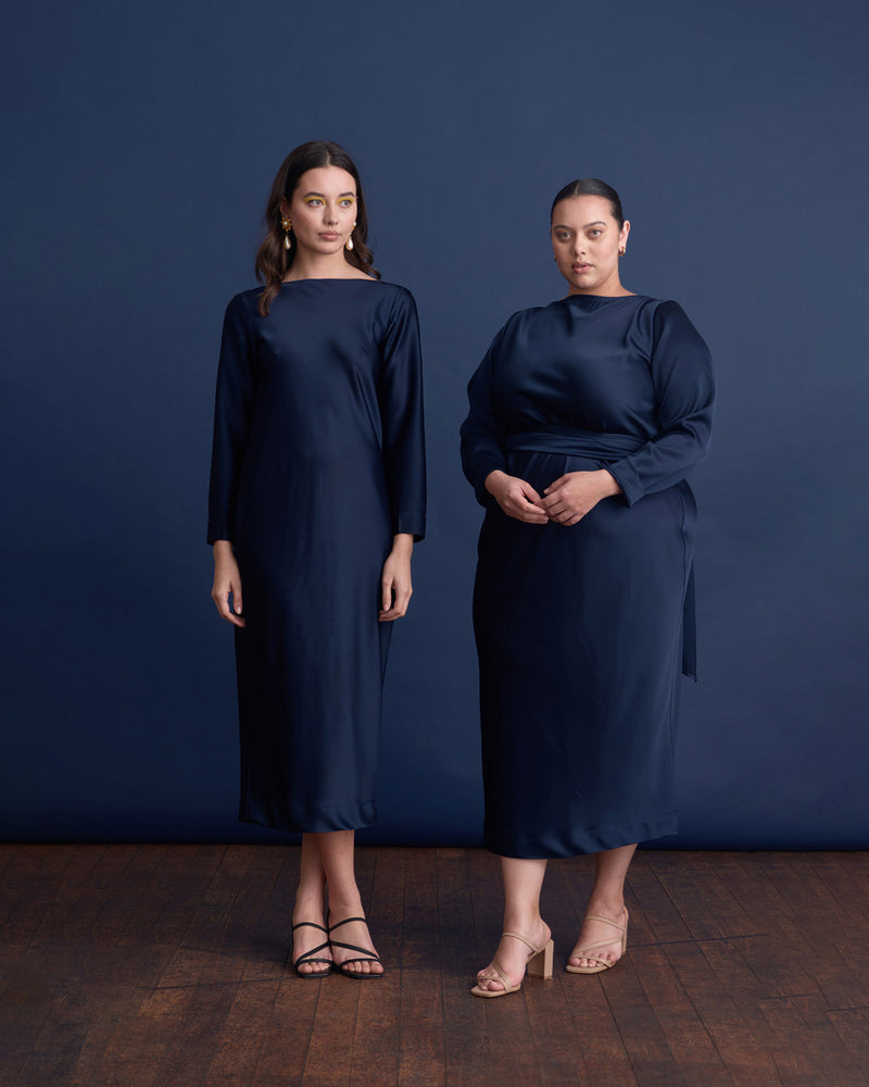 OMNIA LONG SLEEVE DRESS NAVY | The Omnia Long sleeve Dress is a bias cut midi dress.