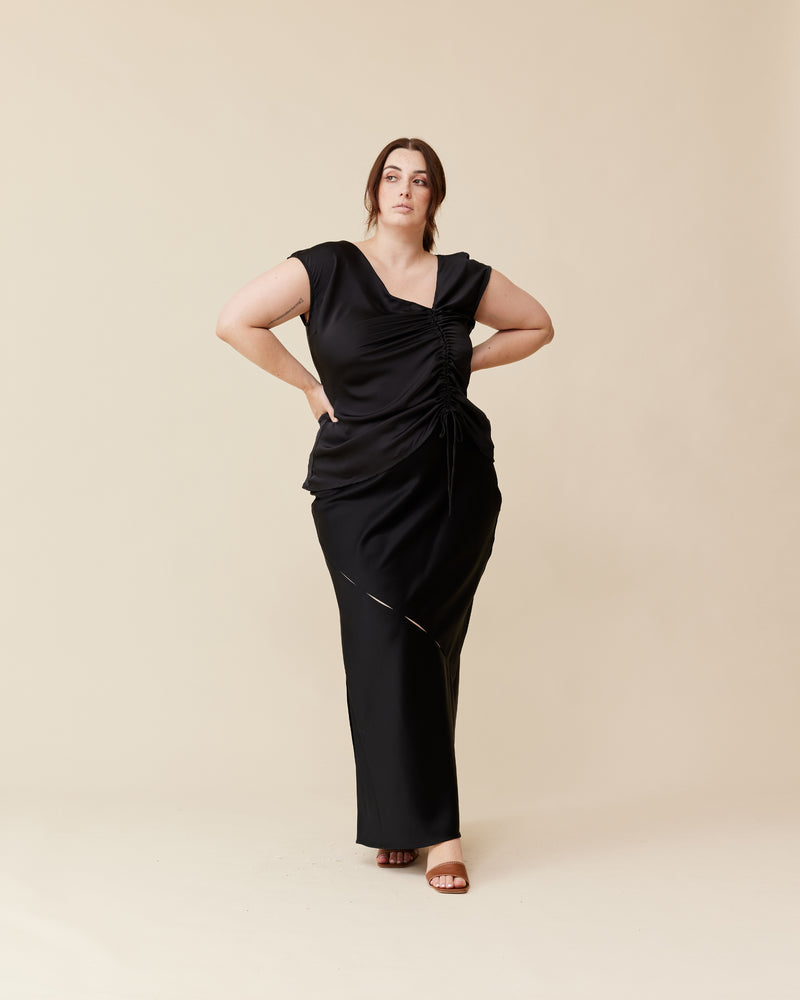 THE TOBY CURTIS BLACK | Bias cut cap sleeve blouse crafted in a lush black satin. This piece has an asymmetrical neckline and a drawstring detail at the side of the piece that creates ruching...