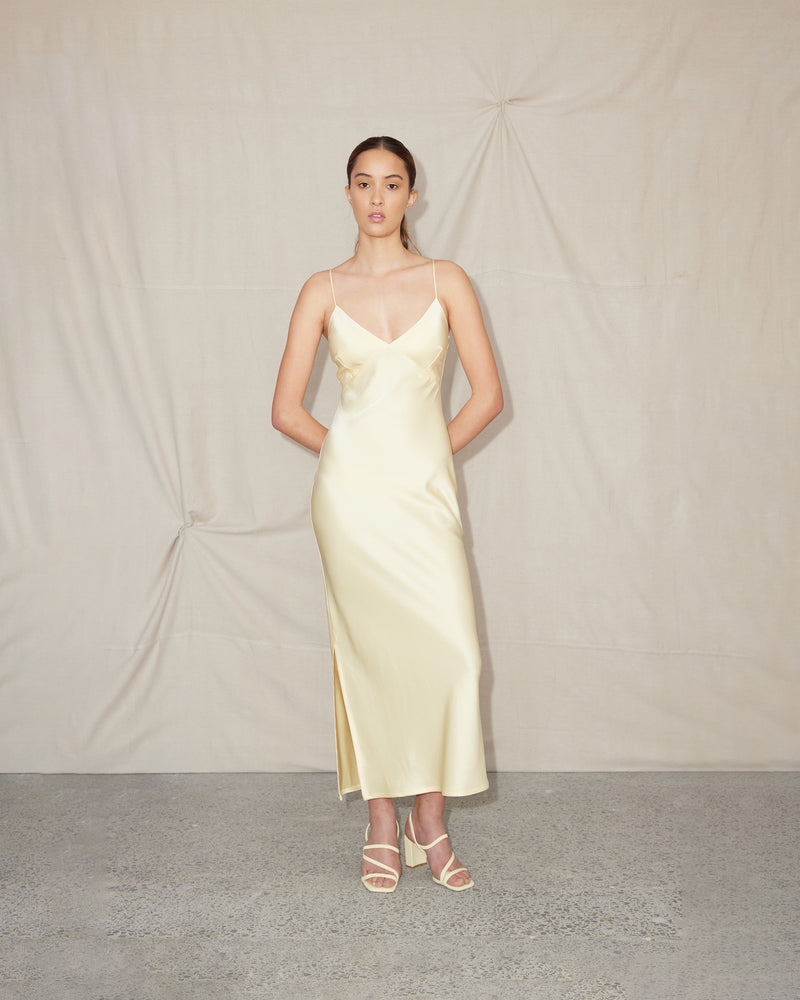 WEIRDLY SLIP BUTTER | Iconic bias cut slip dress with plunging neckline in a new longer length. A wardrobe staple in heavy weight double satin that is lush to wear, in a sheeny butter...