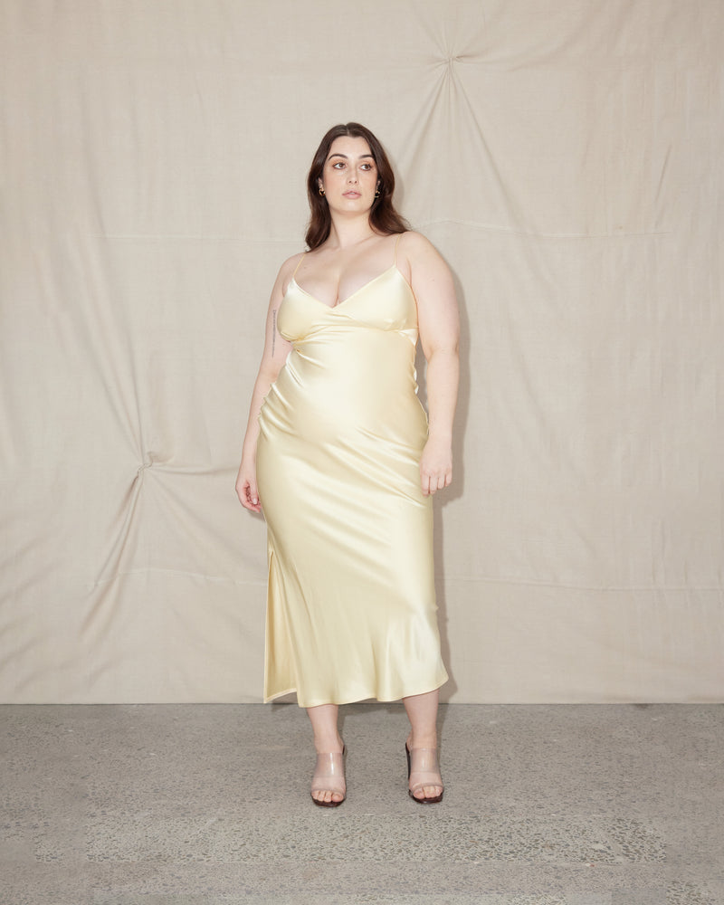 WEIRDLY SLIP BUTTER | Iconic bias cut slip dress with plunging neckline in a new longer length. A wardrobe staple in heavy weight double satin that is lush to wear, in a sheeny butter...