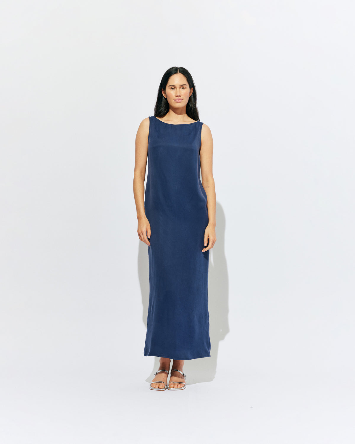 LIZ GOWN MULHOLLAND NAVY CUPRO | Liz is a relaxed fit sleeveless gown with a wrap feature, accentuated with long waist ties, that can be tied around the body or at the back in a bow. Imagined in a buttery soft navy magnolia cupro. 