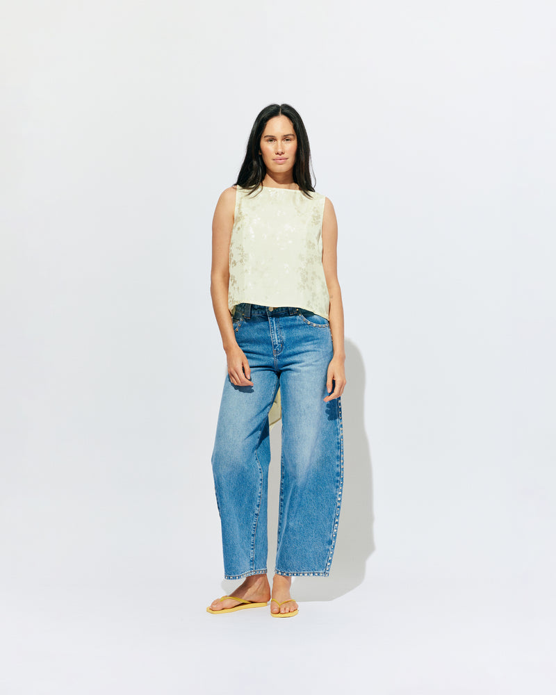 LIZ TOP BUTTER JACQUARD | Liz is a relaxed fit sleeveless top with a wrap feature, accentuated with long waist ties that can be tied around the body or at the back in a bow. Imagined in a sheeny jacquard satin, when this fabric catches...