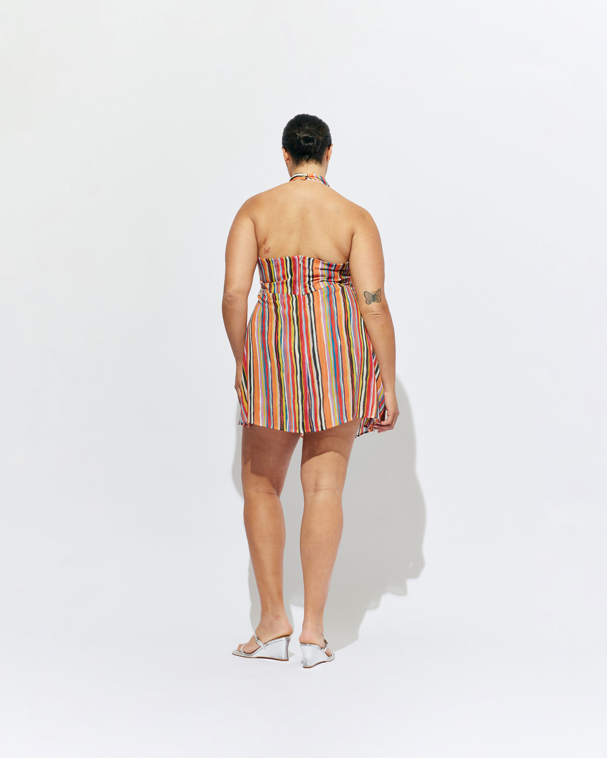 MADRID MINI DRESS LIQUORICE STRIPE | The newest addition to our Madrid story, this mini halter dress is designed in a vibrant liquorice stripe. Featuring a waist tie gather and open back, this dress is perfect over pants or as a statement on it's own.