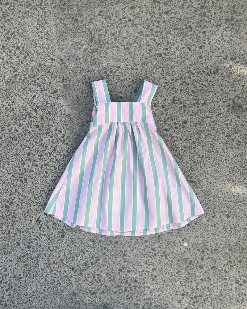 RUBÉBÉ MARGIE TIE MINI DRESS PINK APPLE STRIPE | One for our Rubébé's! Cotton mini dress with a square band at the chest. The skirt falls into an A-line shape with a bow tie closure at the back. Make...