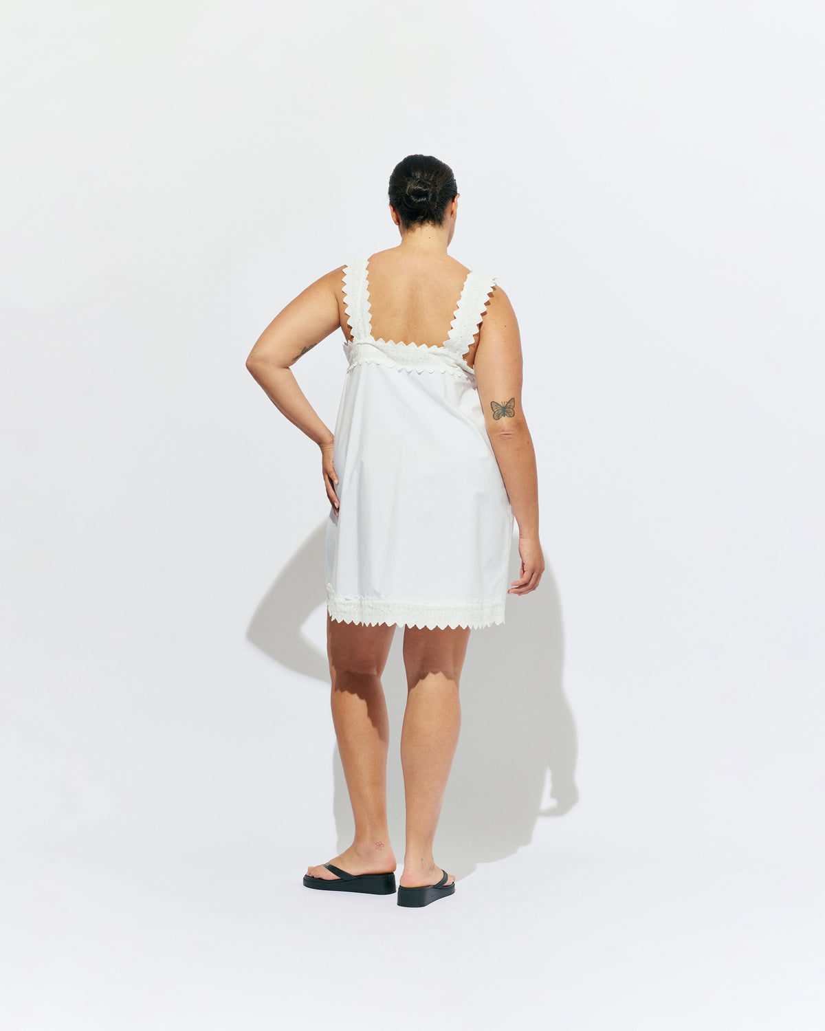 MARGIE LACE MINI DRESS WHITE | An update to our Margie Mini Dress crafted in a white organic cotton, with broderie detailing along the straps and across the bust. With a flowy silhouette through the body, this dress will keep you cute and cool in the...