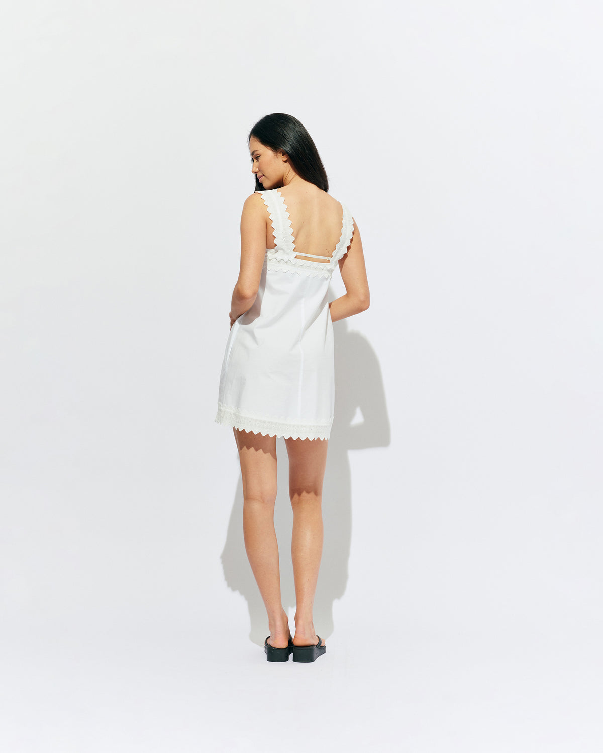 MARGIE LACE MINI DRESS WHITE | An update to our Margie Mini Dress crafted in a white organic cotton, with broderie detailing along the straps and across the bust. With a flowy silhouette through the body, this dress will keep you cute and cool in the...