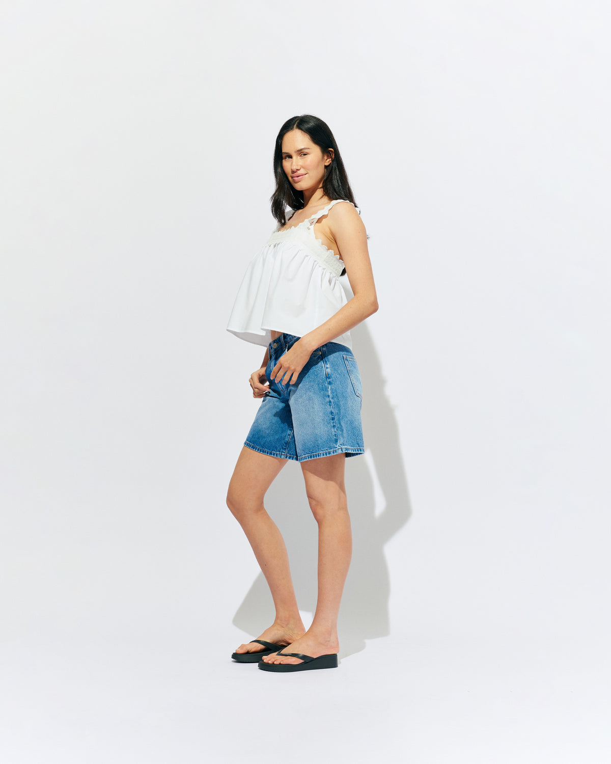 MARGIE LACE TOP WHITE | An update to our Margie Tie-back Top, this cami is crafted in a white organic cotton, with broderie detailing along the straps and across the bust. With a flowy silhouette through the body, this top will keep you cute and...