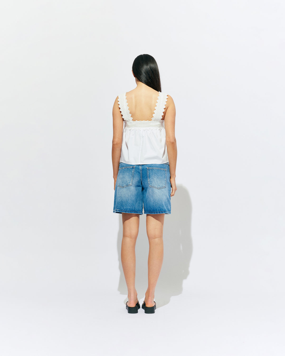 MARGIE LACE TOP WHITE | An update to our Margie Tie-back Top, this cami is crafted in a white organic cotton, with broderie detailing along the straps and across the bust. With a flowy silhouette through the body, this top will keep you cute and...