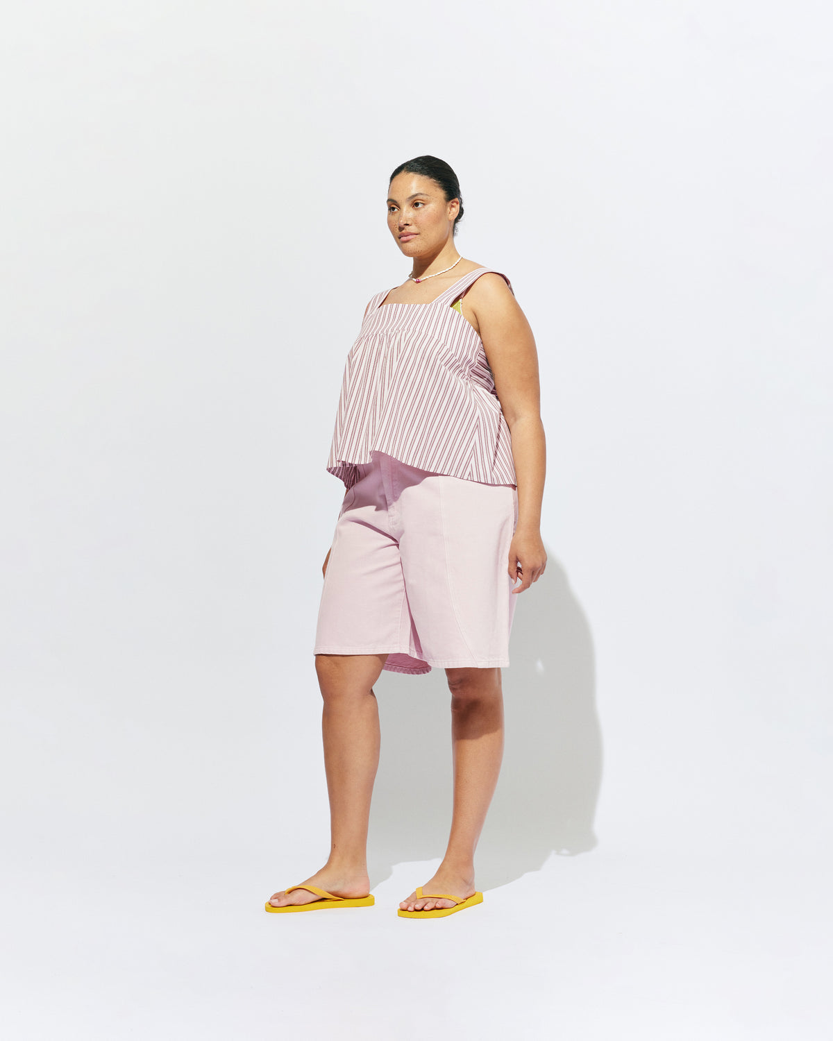 MARGIE TIE-BACK TOP PINK LADY STRIPE | Sleeveless organic cotton top with a square band at the bust, designed in our pink lady stripe. Features a bow tie detail at the back and a cut-out, this is the cutest summer top worn with your favourite denim.