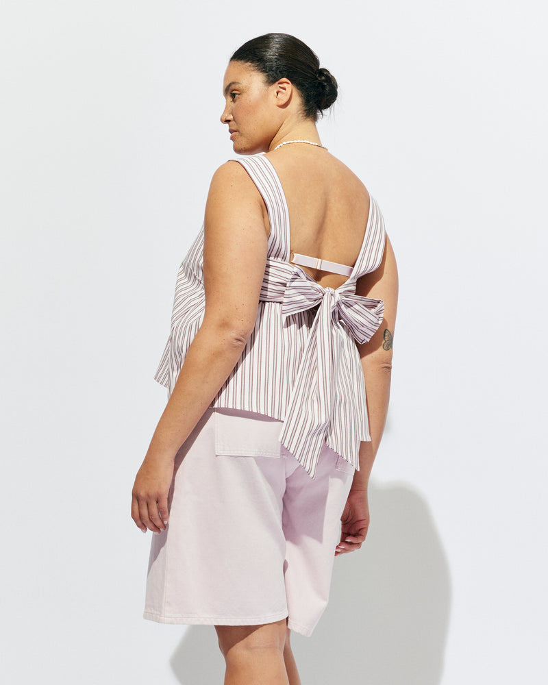 MARGIE TIE-BACK TOP PINK LADY STRIPE | Sleeveless organic cotton top with a square band at the bust, designed in our pink lady stripe. Features a bow tie detail at the back and a cut-out, this is the cutest summer top worn with your favourite denim.