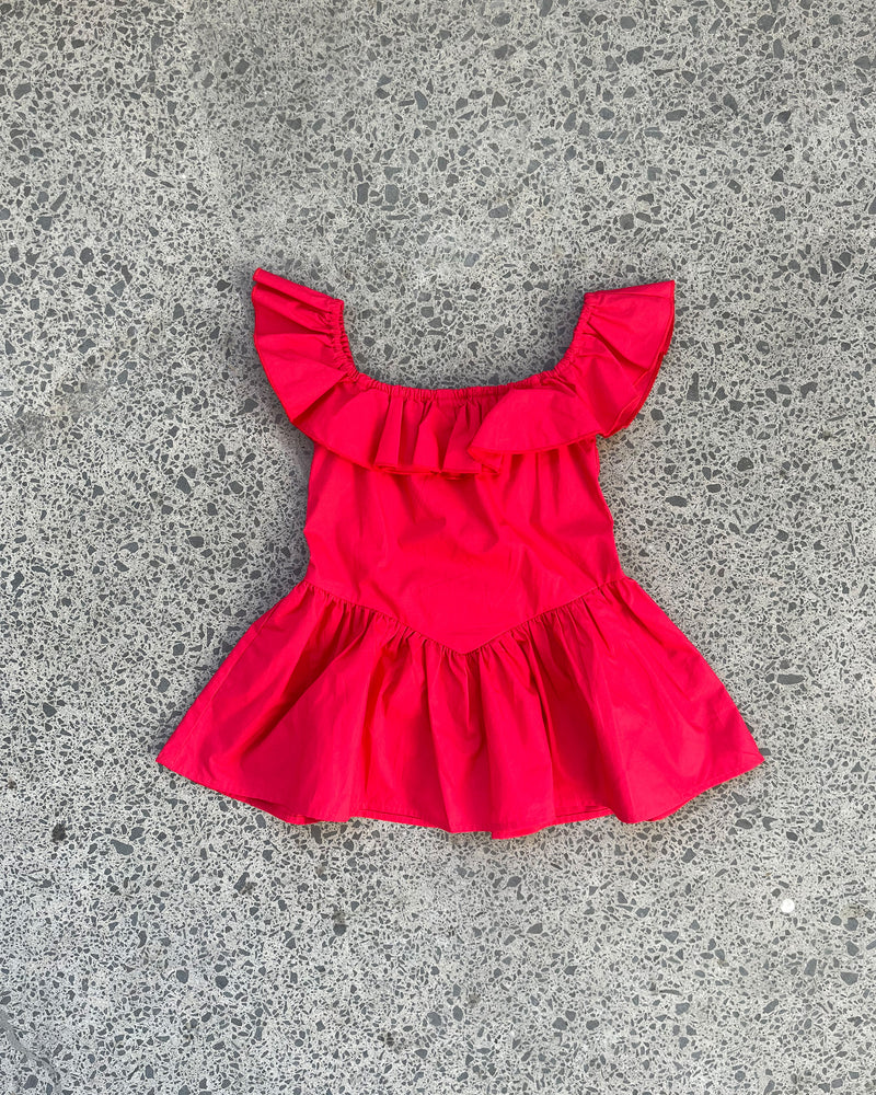 RUBÉBÉ MONACO SUNDRESS CHERRY | One for our Rubébé's! Cap sleeve mini dress with a feature ruffle across the neckline and sleeve. This dress has a fitted bodice with a dropped waist and falls to...