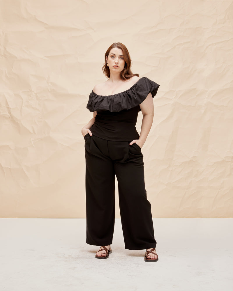 PARLOUR TOP BLACK | Off shoulder slim fit top with a feature frilled detail around the neckline, arm and back. The ruffle is designed in a cotton to emphasise the shape and the top is...