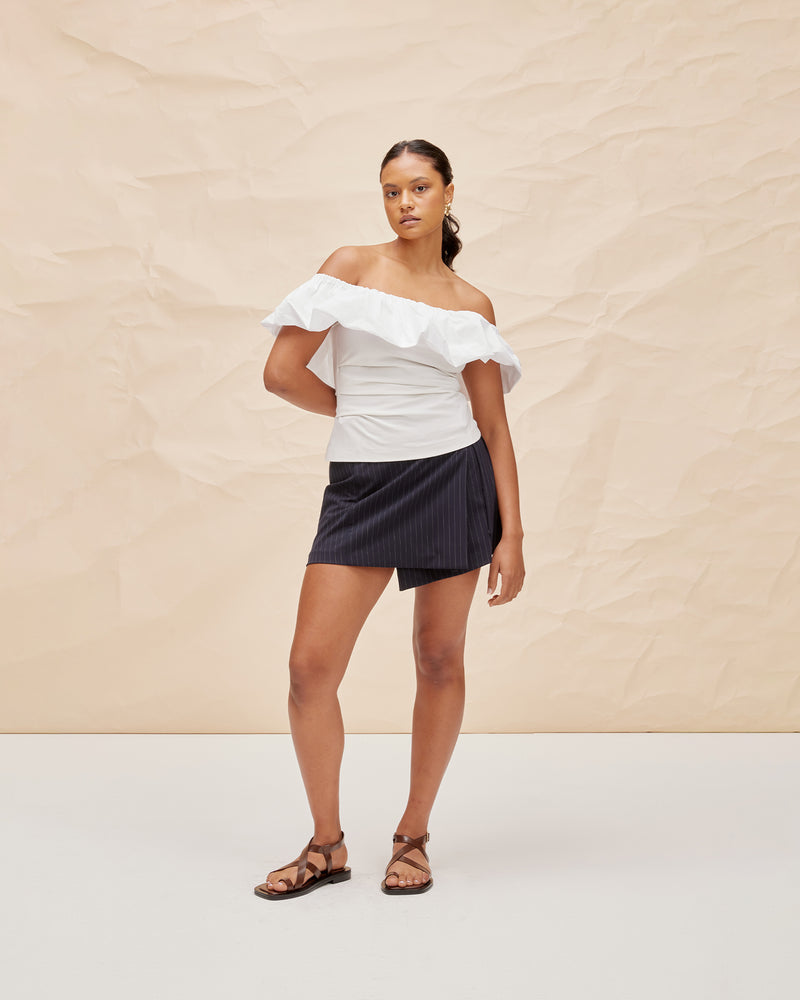 PARLOUR TOP WHITE | Off shoulder slim fit top with a feature frilled detail around the neckline, arm and back. The ruffle is designed in a cotton to emphasise the shape and the top is...