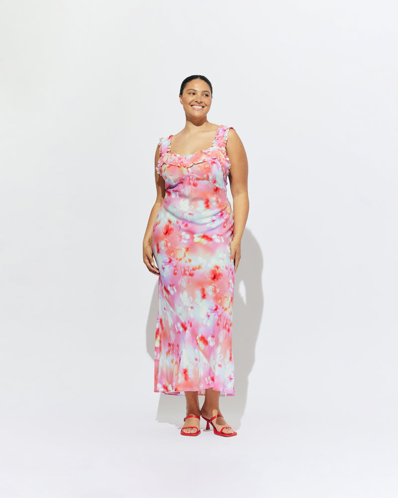 PASSIONFRUIT DRESS GLOWY FLORAL | Sleeveless maxi dress with ruffle details along the neckline and straps, designed in our vibrant glowy floral ~ the perfect fun piece to add to your eventwear rotation. Style with the Lydia Head Scarf for a matching look.