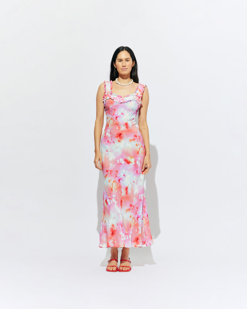 PASSIONFRUIT DRESS GLOWY FLORAL | Sleeveless maxi dress with ruffle details along the neckline and straps, designed in our vibrant glowy floral ~ the perfect fun piece to add to your eventwear rotation. Style with the Lydia Head Scarf for a matching look.