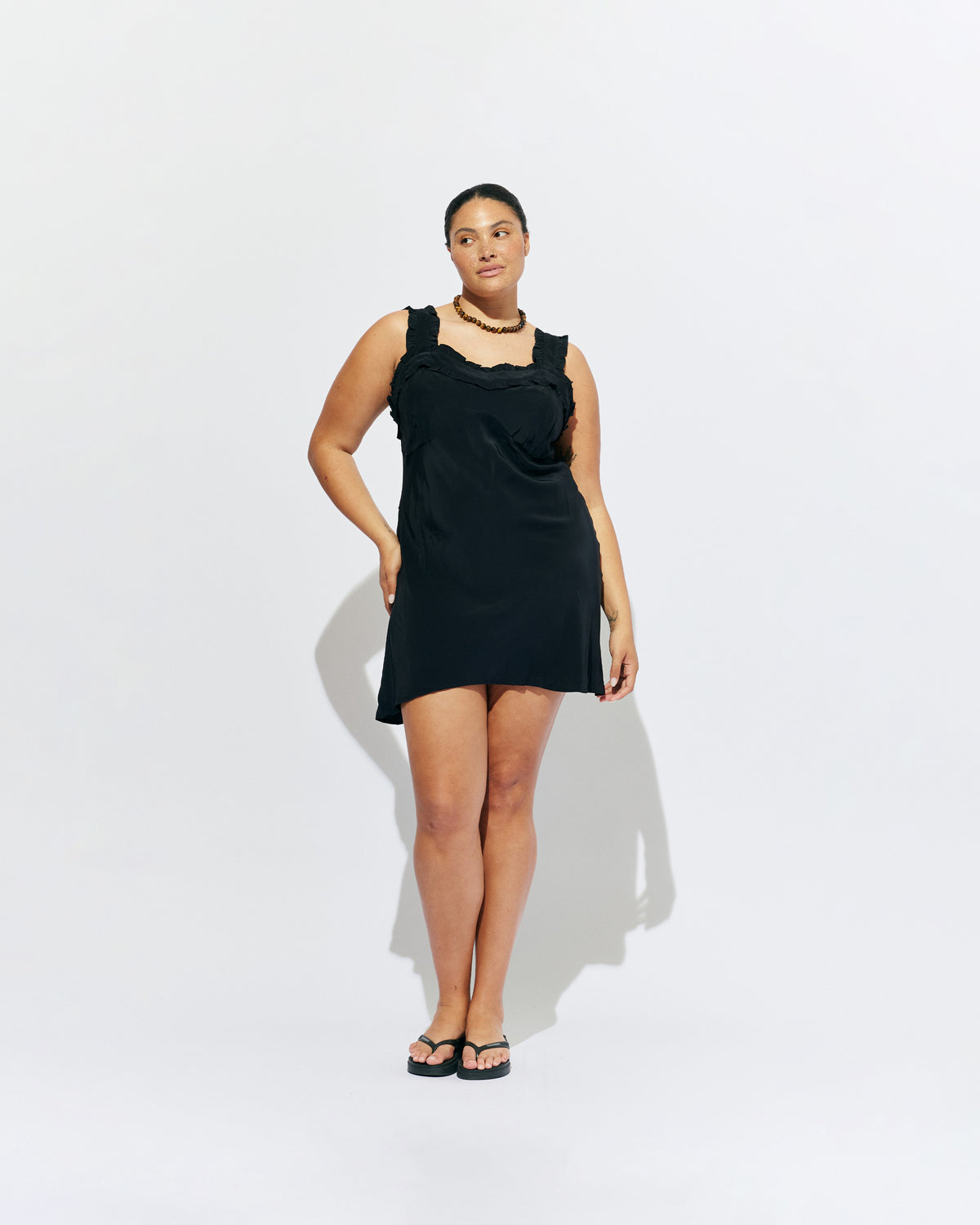 PASSIONFRUIT MINI DRESS BLACK | Mini slip dress with ruffle details, designed in black viscose. With a soft vintage look, this is the perfect light-weight summer dress, or a cute layering piece for cooler weather. 