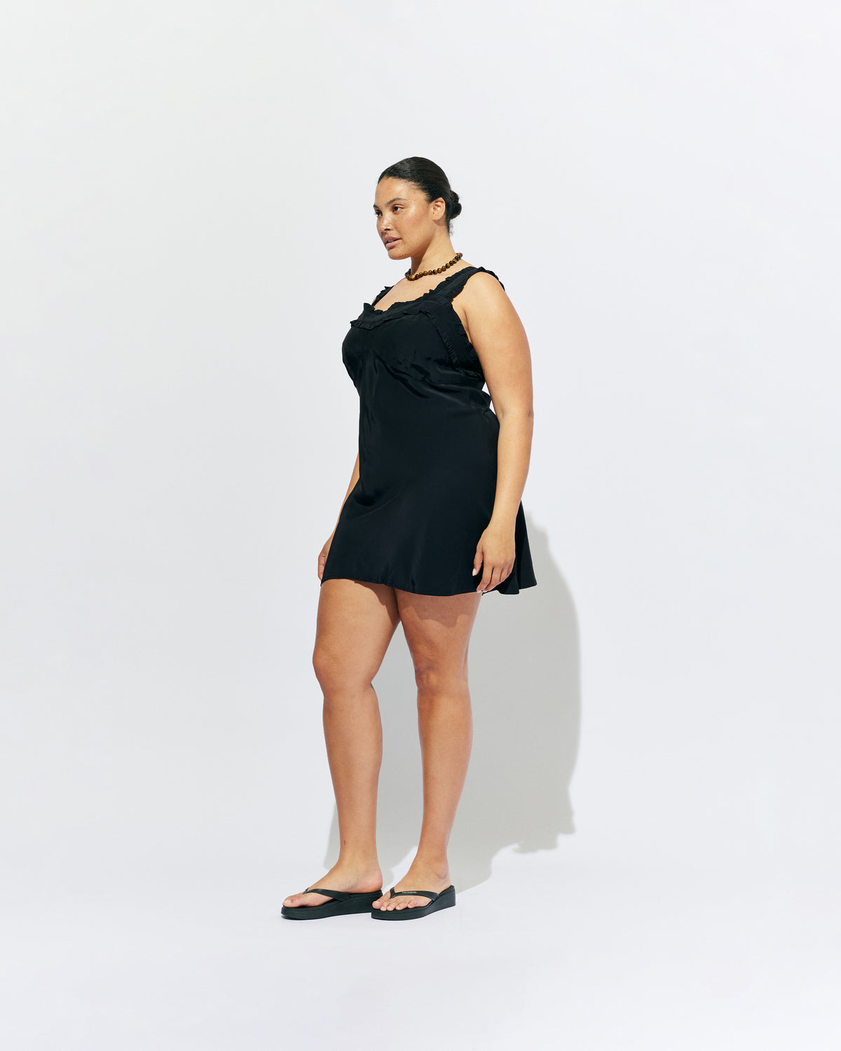 PASSIONFRUIT MINI DRESS BLACK | Mini slip dress with ruffle details, designed in black viscose. With a soft vintage look, this is the perfect light-weight summer dress, or a cute layering piece for cooler weather. 