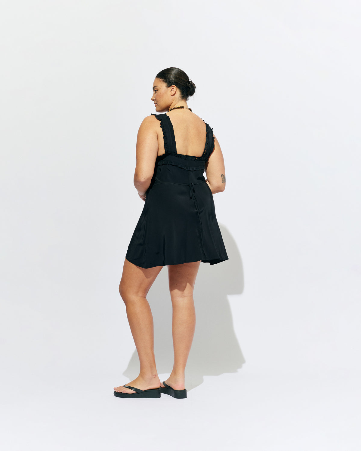 PASSIONFRUIT MINI DRESS BLACK | Mini slip dress with ruffle details, designed in black viscose. With a soft vintage look, this is the perfect light-weight summer dress, or a cute layering piece for cooler weather. 