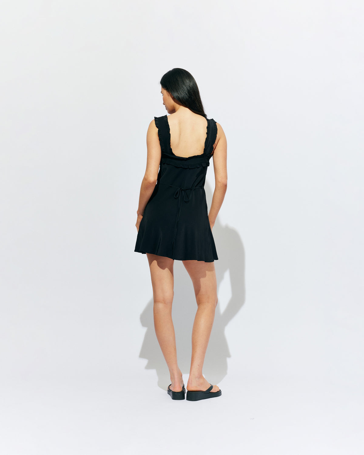 PASSIONFRUIT MINI DRESS BLACK | Mini slip dress with ruffle details, designed in black viscose. With a soft vintage look, this is the perfect light-weight summer dress, or a cute layering piece for cooler weather. 