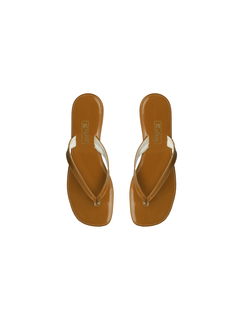 RELAXE SANDALS CARAMEL | Handmade flat sandals designed with leather straps, cork heel and rubber sole. Designed in a caramel colour, these sandals are the perfect Resort accessory.