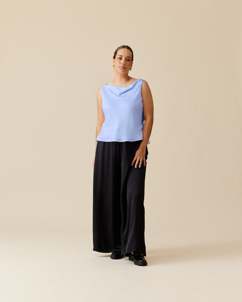 FIREBIRD COWL SLEEVELESS TOP SERENITY | Sleeveless top crafted in a luxe serenity blue satin. Features a minimal silhouette with a cowl back detail and a tie to cinch in the waist.
