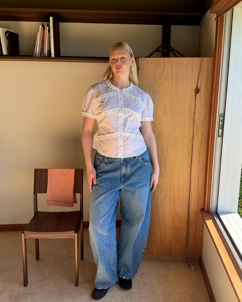 MARTHA BLOUSE WHITE | An update to our Martha Top, this blouse is designed in a semi-sheer organic cotton and features ruffle detailing around the neckline, sleeves and front. Pair with denim for a sweet and simple look. 