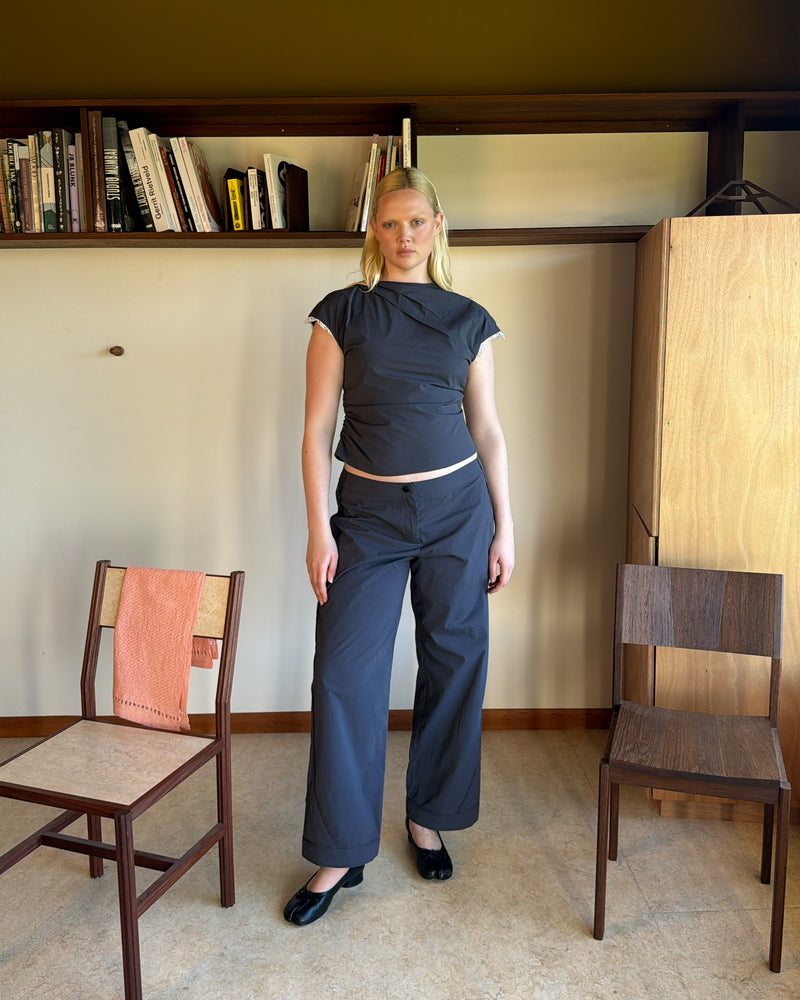 BOWIE TOP CHARCOAL | Short sleeve top crafted in a charcoal organic cotton, featuring a high neck collar, lace trim, and gathered detailing on the lower back and side seam, designed for better fit and movement. Perfect for any occasion, this versatile piece pairs...