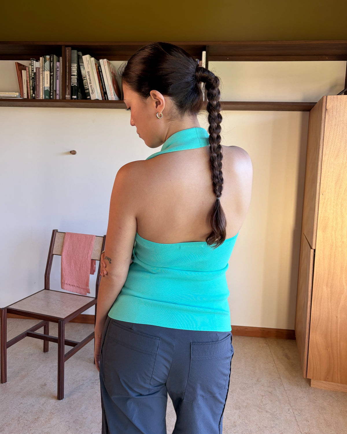 RUDI TANK AQUA | A twist on the classic halter tank with an oversized strap designed to sit gathered around the neckline, crafted in a mid-weight aqua knit. This tank is designed to be worn tight and hold you in when worn. Pair with...
