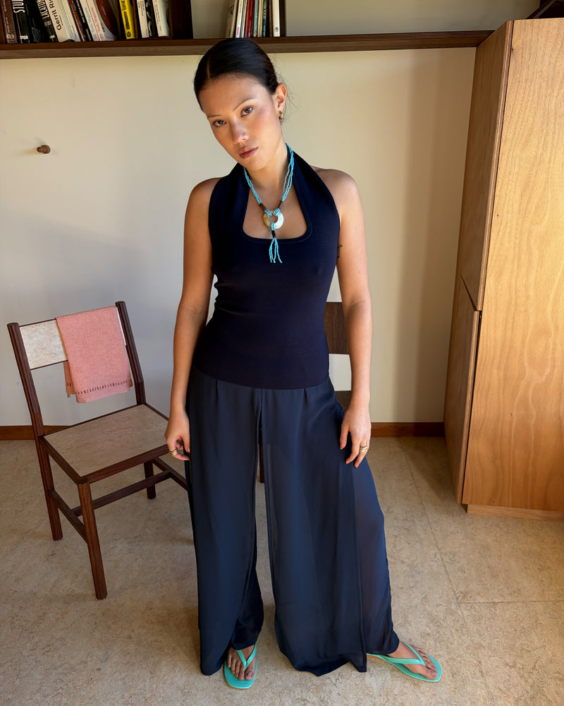 RUDI TANK NAVY | A twist on the classic halter tank with an oversized strap designed to sit gathered around the neckline, crafted in a mid-weight navy knit. This tank is designed to be worn tight and hold you in when worn. Pair with...