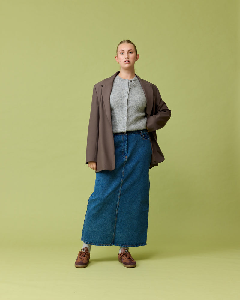 SUBLIME DENIM MAXI SKIRT INDIGO | Mid-rise straight-cut denim skirt with metal hardware in indigo denim. Features a back split for ease of movement and a maxi length.