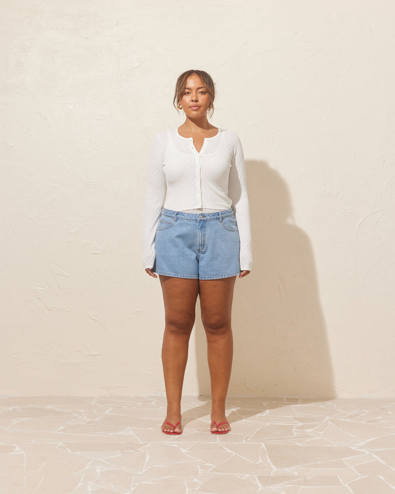 BLINK DENIM MICRO SHORT LIGHT BLUE | Denim micro shorts designed in a light blue wash. Features a low-rise, with a 5-pocket design and a zip fly. An easy summer throw-on short.