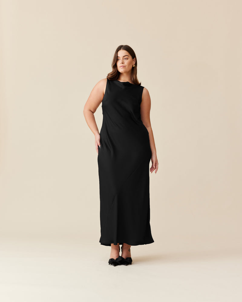 FIREBIRD COWL GOWN BLACK | Sleeveless midi dress crafted in luxe black satin. Features a minimal silhouette with a cowl back detail and a tie to cinch in the waist.
