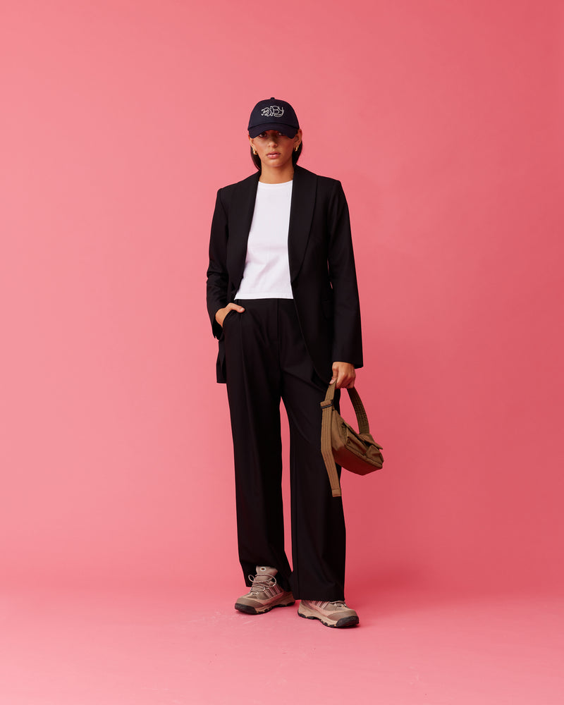 CARMY TROUSER BLACK | A high-waisted update on our favourite Rue Trouser. Features a wide leg a flat waistband and belt loops. These pants are versatile in that they can be worn casual with a...
