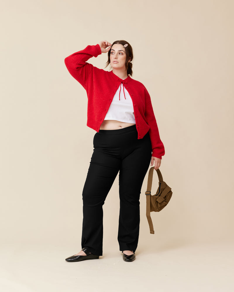 ANNIE CARDIGAN CHERRY RED | Crew neck cardigan with a button-down placket, designed in a cosy aplaca wool blend. This cardigan comes with a detachable bow-tie, to style on the cardigan through the buttonhole, in...