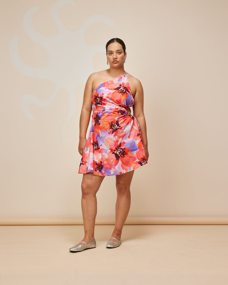 BETTINA CUT OUT MINIDRESS POPPY FLORAL | Asymmetrical one shoulder mini dress with a circular cut-out at the waist, designed in a striking red and purple poppy floral. This dress is designed to be a stand-out.
