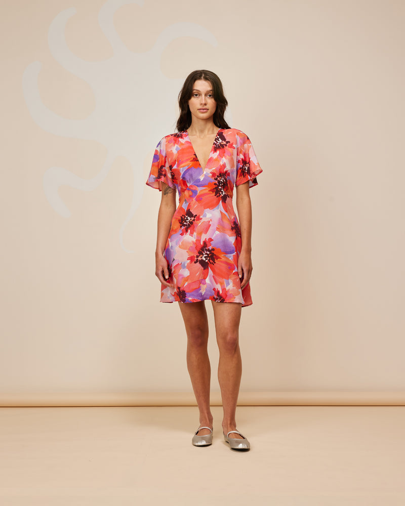 BETTINA SILK MINIDRESS POPPY FLORAL | A Rubette favourite now imagined in a striking red and purple poppy floral silk. Features a V-neck neckline with short fluted sleeves. A seam detail under the bust and a...